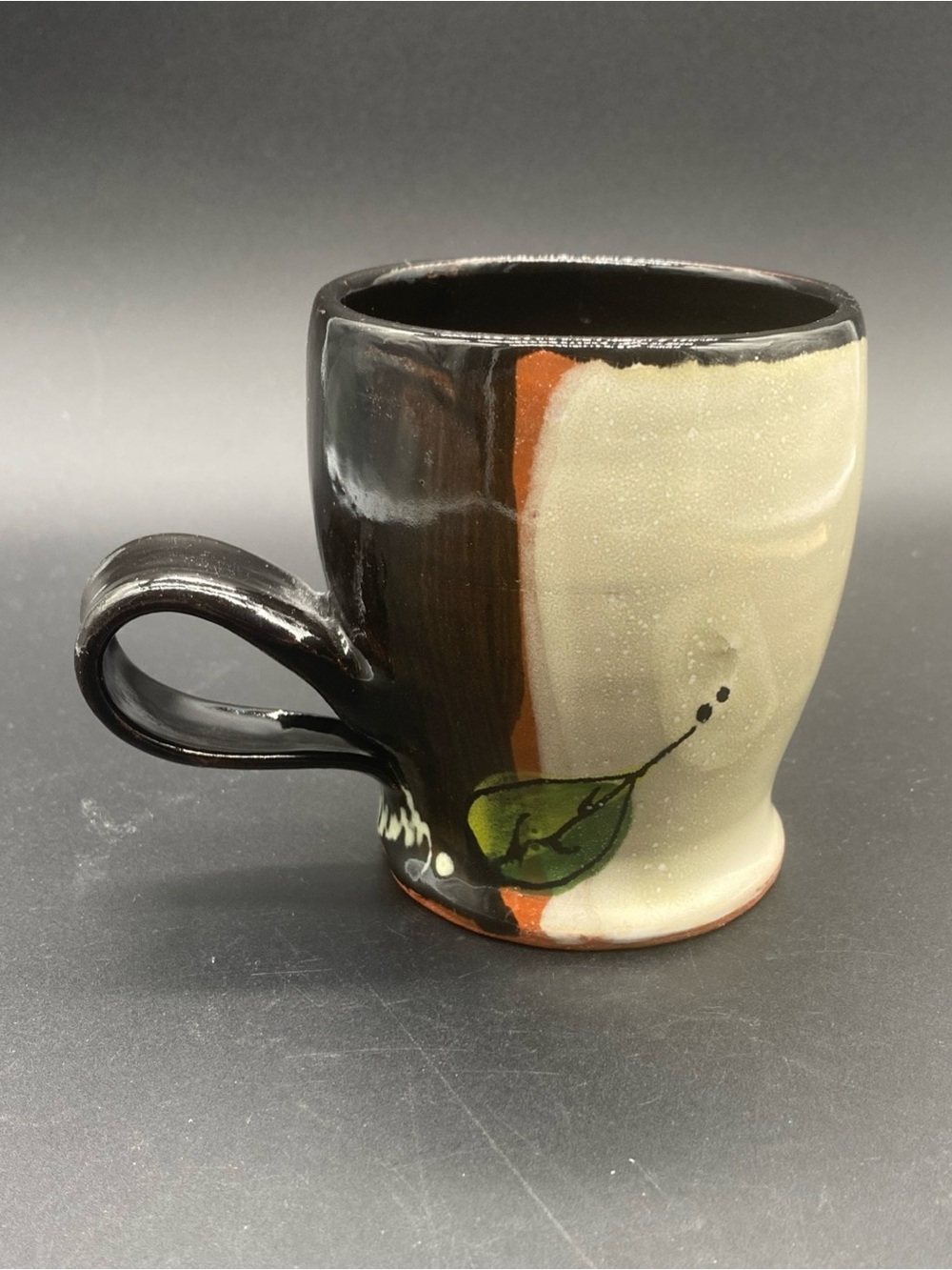 Handcrafted Two-Tone Ceramic Mug with Leaf Motif, made with red clay.
